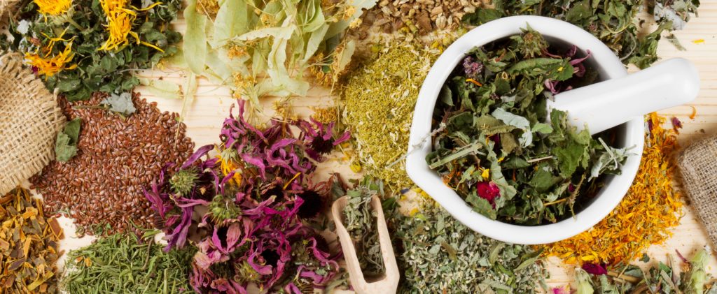 healing herbs on wooden table, herbal medicine
